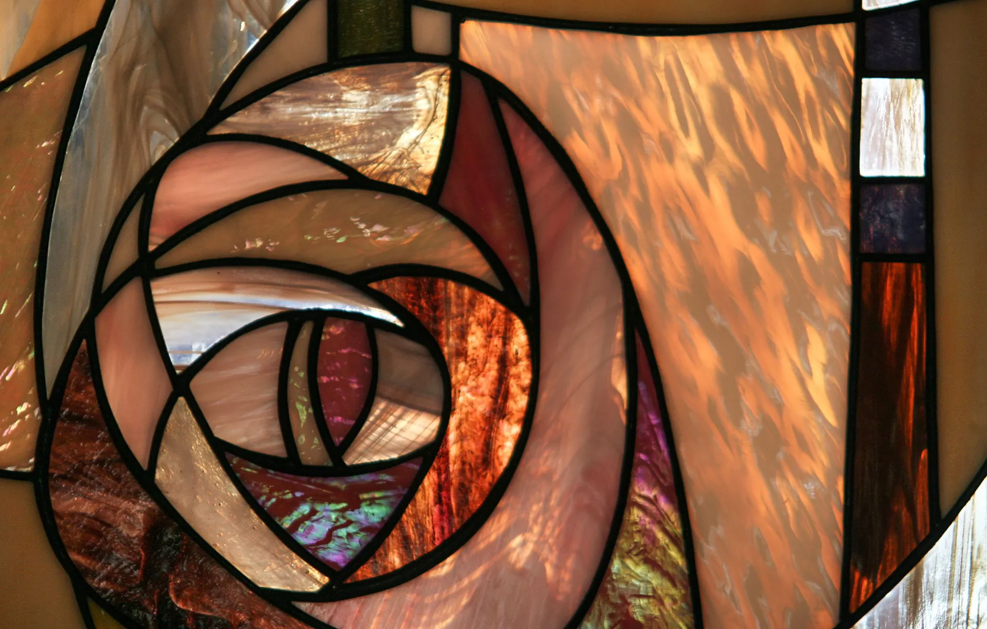 Art Nouveau stained glass rose in copper and blush tones